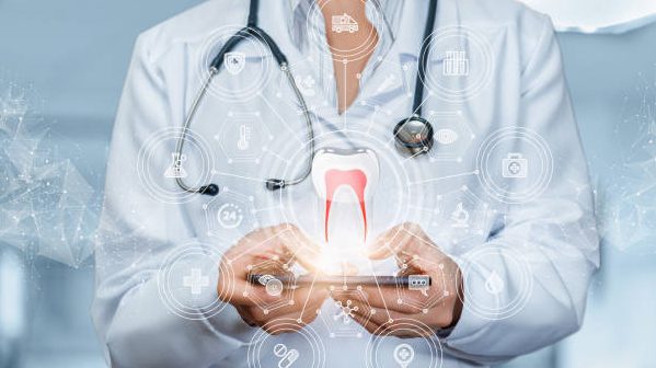 Doctor dentist working on the phone on a blurred background.